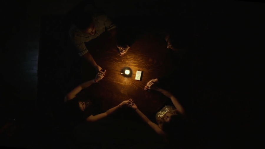 Kim, Sasha, John and Elliot hold a seance in their home.