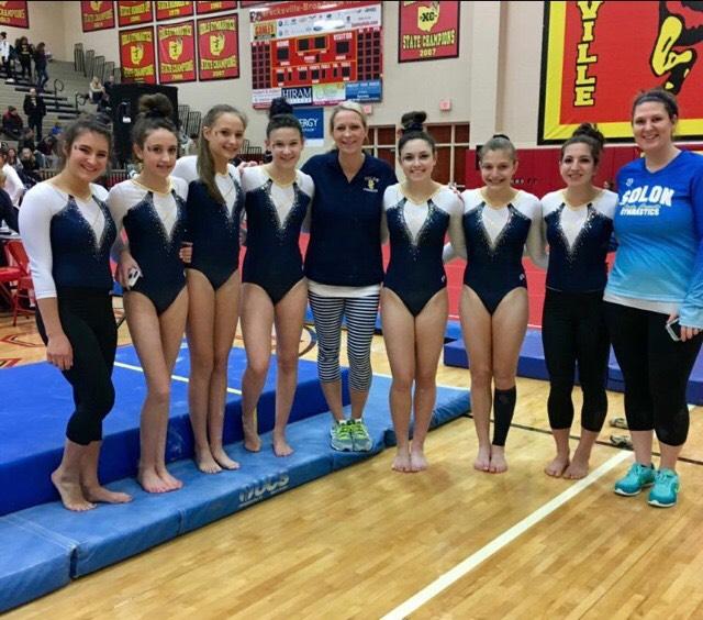 The+girls+gymnastic+team+poses+after+a+recent+meet.