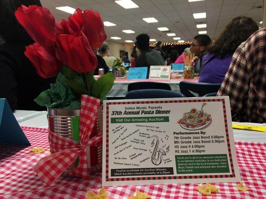 The theme of this year’s Pasta Dinner was Italy, and the Music Parents decorated the cafeteria in accordance with it. Tables were adorned with centerpieces of flowers and spaghetti noodles in tomato cans, lights and black curtains were hung behind the makeshift “stage,” and bowtie noodles were scattered across the checkered tablecloths.