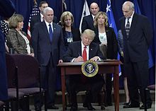 President Trump signs an executive order at a ceremony at DHS Headquarters.