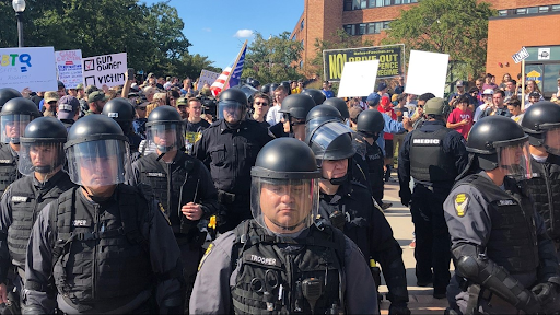 Police officers stand, ready to intervene during the pro-gun walk on the Kent State campus. Photo Credit: https://media.wkyc.com/assets/WKYC/images/599390334/599390334_1140x641.jpg

