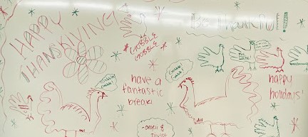 SHS students Divjot Kaur and Angeli Thompson express their thanks on a classroom white board
