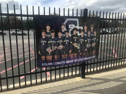 Team photo of the Solon Boys Soccer Seniors hangs outside Stewart Field