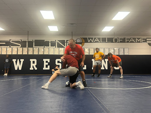Wrestling coach teaches useful tactic to the wrestling team.