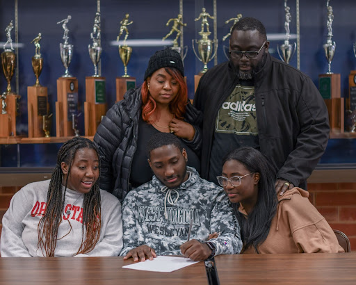 Will Johnson accompanied by family while signing national letter of intent