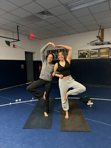 Yoga 2.0 students Lillian Newby and Heather Cook doing  the partner tree pose during class. 