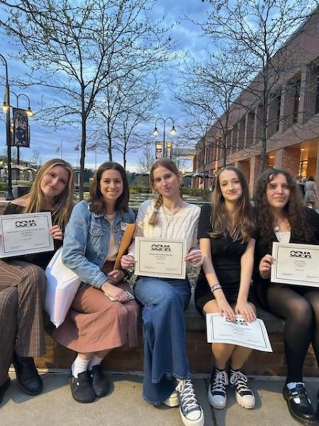 From left to right, Senior Sasha Zahler, Advisor Maggie Locke, Senior Mia Ray, Sophomores Lucy Jacobsen and Sam Patton pose with their awards after the Ohio Scholastic Media Association Awards Banquet held at Kent State University. 