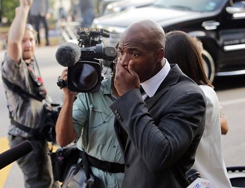 Adrian Peterson leaves the courthouse upon being reinstated after his initial suspension.