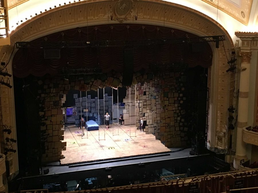 The show's adult ensemble members warming up on stage before the show. 