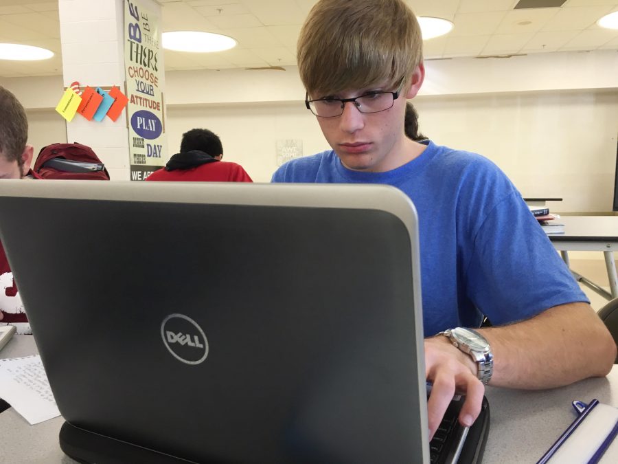 Senior saxophone squad leader Daniel Prokopius prepares the petition in the SHS senior commons. 