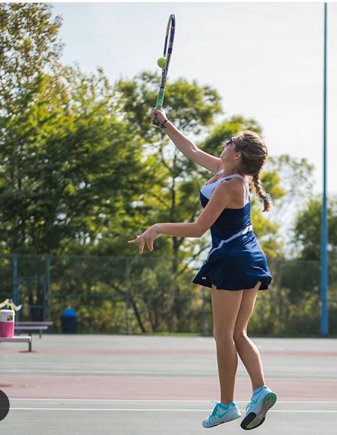 Co-Captain Lindsey Blashka on the Solon tennis Courts competing in a doubles match. 