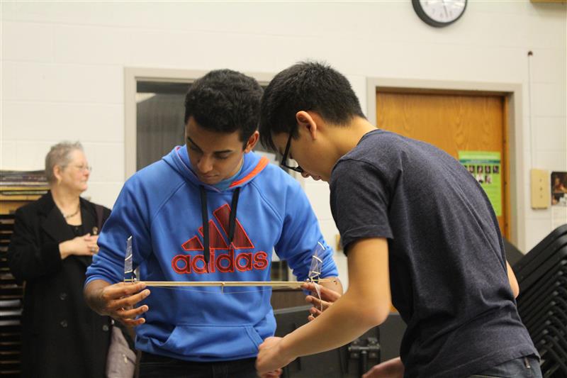 Senior Vishal Sundaram, left, and junior David Ye inspect one of their creations.