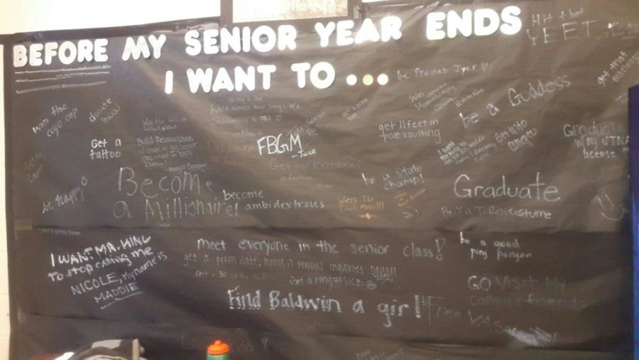 Seniors write what they wish to accomplish during their last year on a poster in Senior Commons.