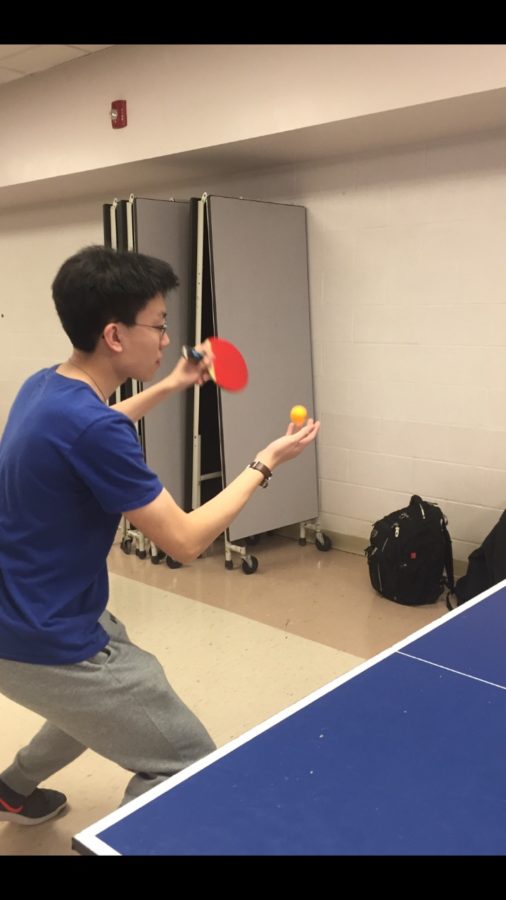 Zou serving a ball in a hard-fought game with Qin.