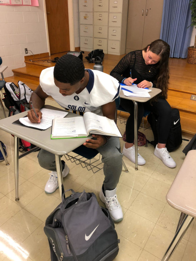 Solon High School students Kevin Perry and Skyla Caito do homework.