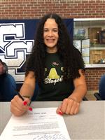 Kiana posing on her signing day. Photo courtesy of Solon Athletics.