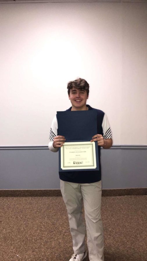 Camden Loeschen with his award from winning districts. He 
will be moving on to states. Captured by Savannah Loeschen.