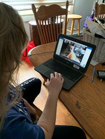 A senior attends her band class via Zoom 