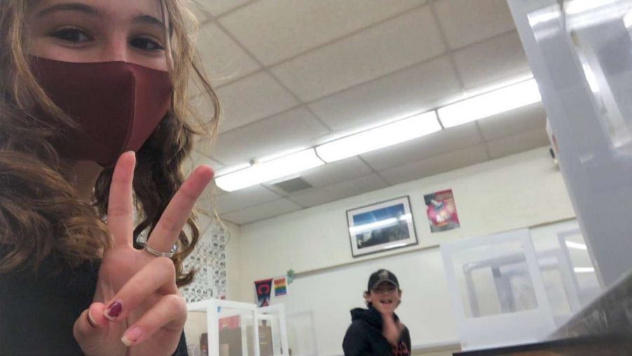 Fellow SHS freshmen Ella Giallanza and Boston Hazelwood in between classes at the school while social distancing and sitting at their desks with plastic screens.