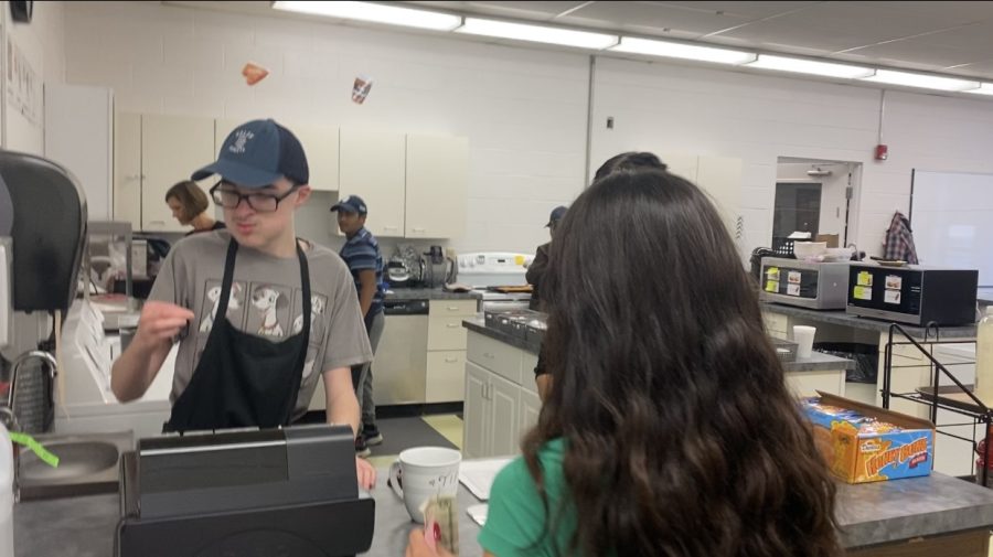 Café worker Joey Woods  works the cash register 