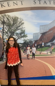 Amanda Schwartz in front of a Kent State poster.