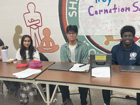 Key Club Officers Zayna Samoon and Rishabh Mehta sell carnations during lunch. 