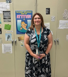 Melissa Hughes standing in front of the cabinet in her classroom. 