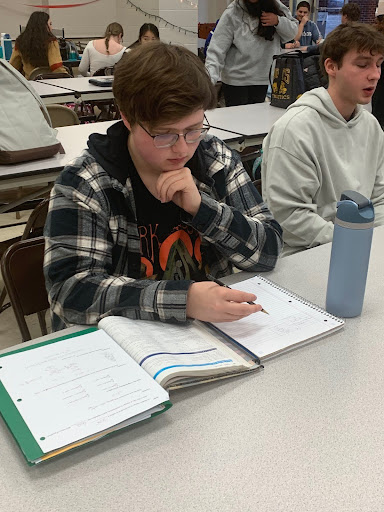 Senior Andrew Hanna studying in Commons.