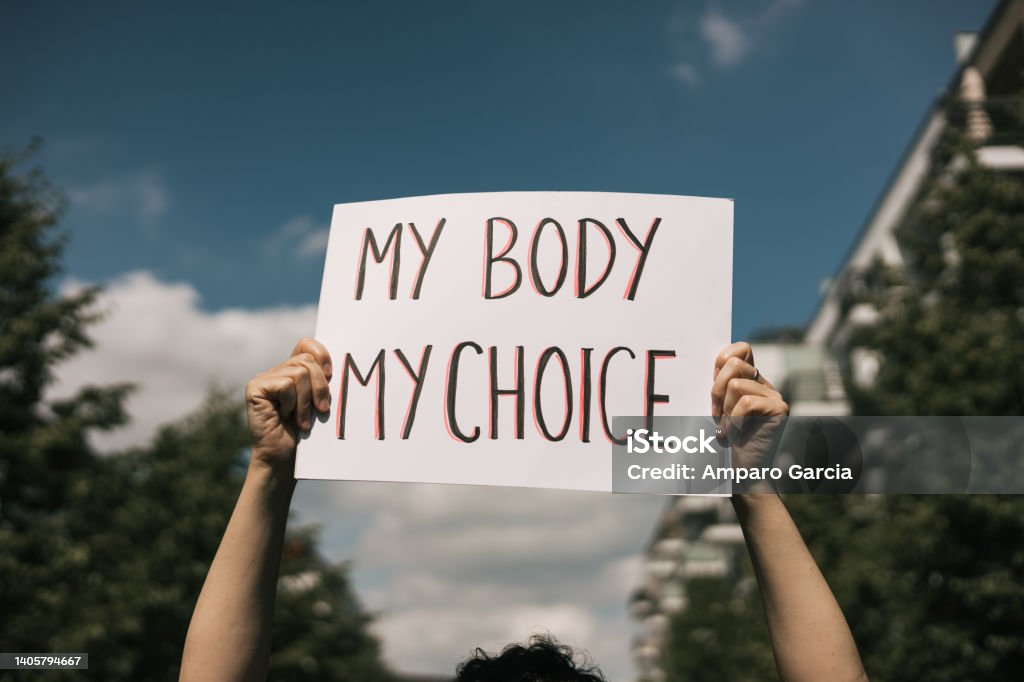 Woman holding a sign "My Body, My Choice." Photo found on iStock. 