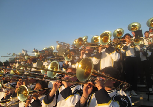 Taken by Lily Rohrich. The trombone section playing at the Kenston football game.