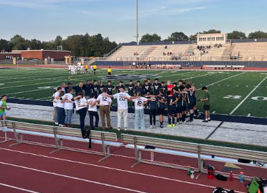 The Solon boys' soccer team in a huddle with their teachers before the game started.
