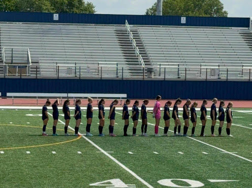 The Solon High School girls soccer team participating in the National Anthem before their game starts. 