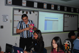 Mr. Fuentes helping one of his fellow students in AP World.