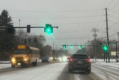Multiple vehicles driving at the Liberty Road and Aurora Road intersection on the snowy morning of Tuesday, Nov. 11.